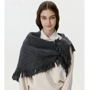 Close-up of charcoal grey wool-blend knit shawl with fine tassel trim detail
