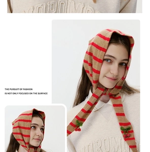 Detail view of striped wool knit balaclava featuring handcrafted cherry bead accents