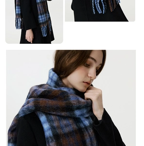 Detail of blue and brown checkered scarf with fringe edges and thick woven texture