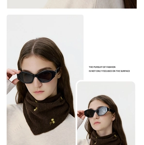 Detail of soft brown knit neck warmer featuring delicate yellow floral embroidery accents