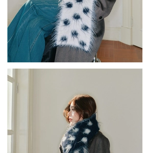 Close-up of soft knitted wool scarf with polka dot pattern and thick warm texture