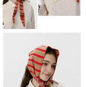 Detail of wool knit striped headscarf with cherry beads decoration on beige sweatshirt