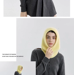 Detailed knit texture of a pale yellow wool blend balaclava on a fashion model