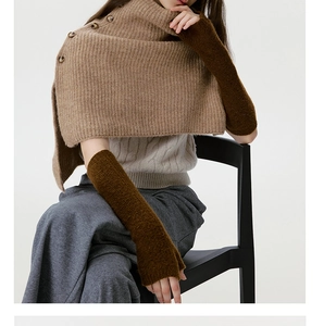 Detail of knit shoulder wrap with buttons and long arm sleeves in earthy tones