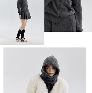 Macro view of grey wool blend knitted balaclava with buttoned cardigan and plush white faux fur