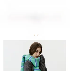 Detail of wool blend striped scarf in blue and green with soft fringe texture