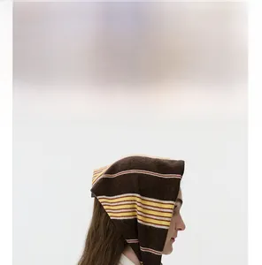 Detail of striped knit bandana showing thick texture and warm autumn color pattern