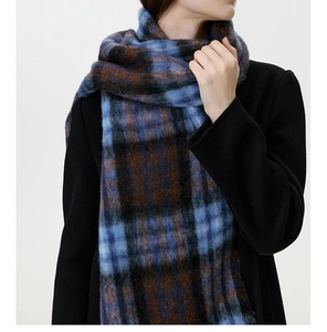Detailed close-up of thick blue and brown plaid scarf with soft brushed wool texture