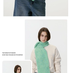 Close-up of fluffy light green wool blend scarf showing soft mohair texture and fringes