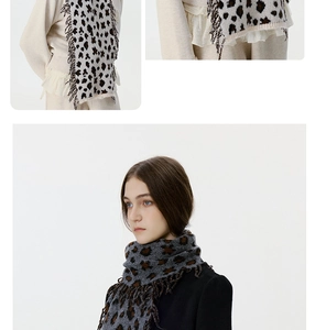 Close-up detail of leopard print knitted scarf showing tassel edges and soft texture