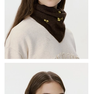 Detail of wool knit scarf with yellow flower embroidery on a brown vintage neck warmer