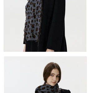 Close-up detail of leopard print knit scarf with fringe and soft textured fabric