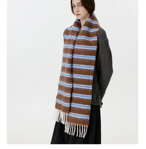 Detail showing wool blend striped scarf with blue and brown patterns and white tassels