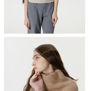 Close-up of soft ribbed knit texture and button detail on beige neck warmer wrap