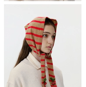 Close-up of wool knitted striped kerchief featuring decorative 3D beaded cherries