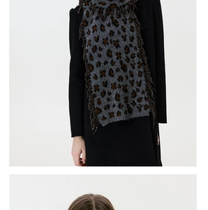 Close-up of leopard print knitted scarf with detailed tassels and thick warm texture