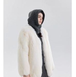 Detailed texture of white faux fur coat paired with a grey knit Balaclava hood