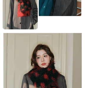 Detail showing the fluffy texture and thick knit of the red and black polka dot wool scarf