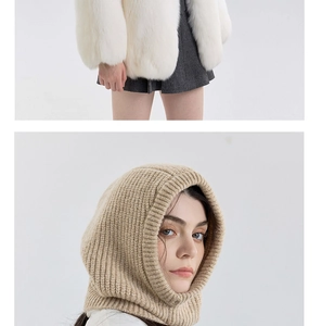 Detail of a beige ribbed knit balaclava scarf paired with a white faux fur jacket