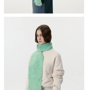 Detail of light green mohair knit scarf and matching five-finger gloves set for winter