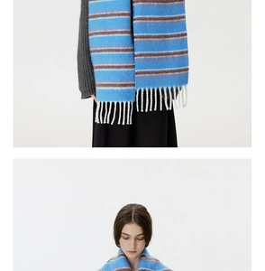 Close-up of blue and brown striped wool blend scarf with decorative white tassels