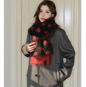 Close-up of fluffy thick red and black knit wool scarf with premium fuzzy texture