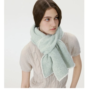 Detail of mint green wool blend knit scarf with contrast white trim and ribbed texture