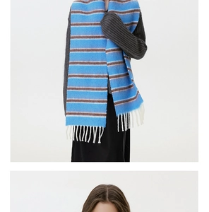 Detail of wool blend striped scarf in blue and brown with long white tassels