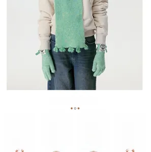 Detailed view of mint green wool blend knitted scarf with fringes and matching gloves
