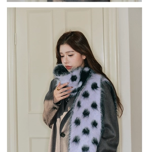Close-up of thick lilac wool scarf with black polka dots and fluffy texture detail