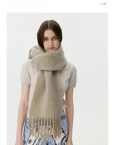 Detail of soft wool blend scarf in beige featuring premium thick knit and long tassels