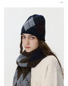 Detail of argyle knit beanie and scarf set with soft plush texture in blue and brown