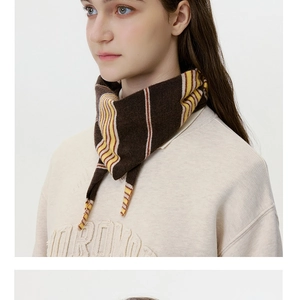 Detail of striped knit triangle scarf with fine texture in brown, yellow and white