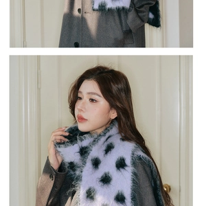 Close-up of soft purple wool scarf with black plush polka dots on grey wool coat