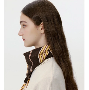 Close-up of striped knit scarf in brown, yellow and beige showing soft texture and style