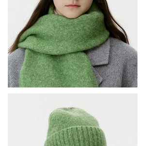 Detail view of grass green marl knit winter beanie and thick matching scarf set