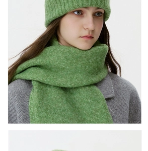 Close-up of fruit green chunky knit beanie and scarf set with soft wool texture