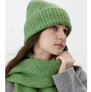 Detail view of grass green ribbed knit hat and scarf set on a child for winter warmth