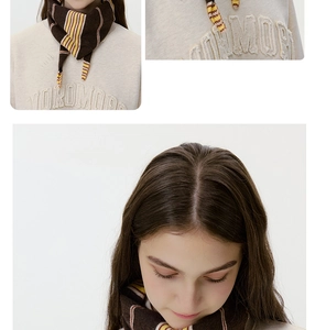 Detail view of striped knit scarf with brown yellow and beige textures and soft fabric