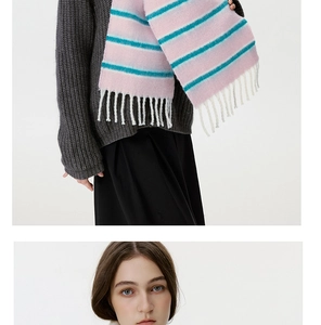 Detail of pink and blue striped wool blend scarf with white fringe tassels