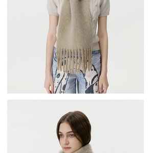 Detail of soft khaki wool blend scarf with fringe tassels and plush mohair texture