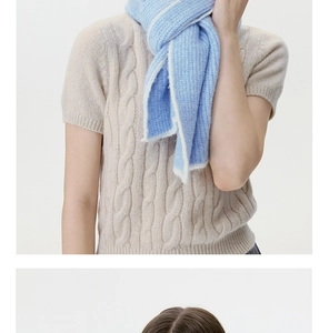 Detailed macro view of the fluffy sky blue and cream white wool blend knitted scarf texture