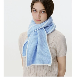 Close-up of soft knit wool blend scarf in light blue with white contrast edges