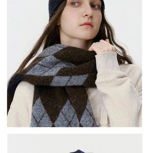 Detailed close-up of argyle knit scarf in brown and grey with premium brushed texture