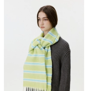 Detail view of soft light green and blue striped wool blend scarf with fringe