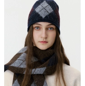 Close-up of argyle knit beanie and scarf set featuring plush wool blend texture