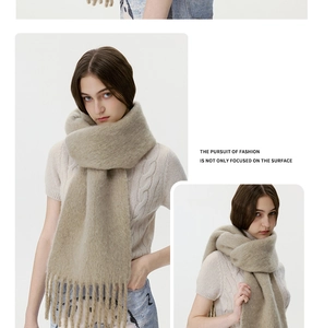Close-up of beige knitted wool blend scarf featuring soft texture and long fringe tassels