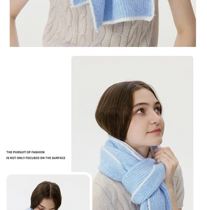 Detailed knit texture of light blue and white striped wool blend scarf with soft fringe