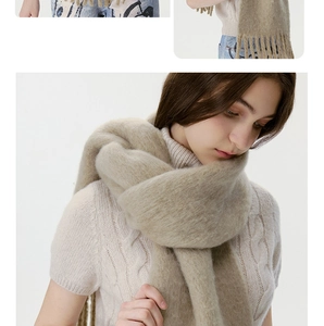 Macro detail of soft beige wool blend scarf with fringe tassels and fluffy texture