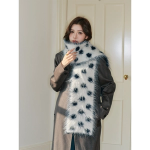 Thick wool polka dot scarf with faux fur trim shown on model in winter outfit